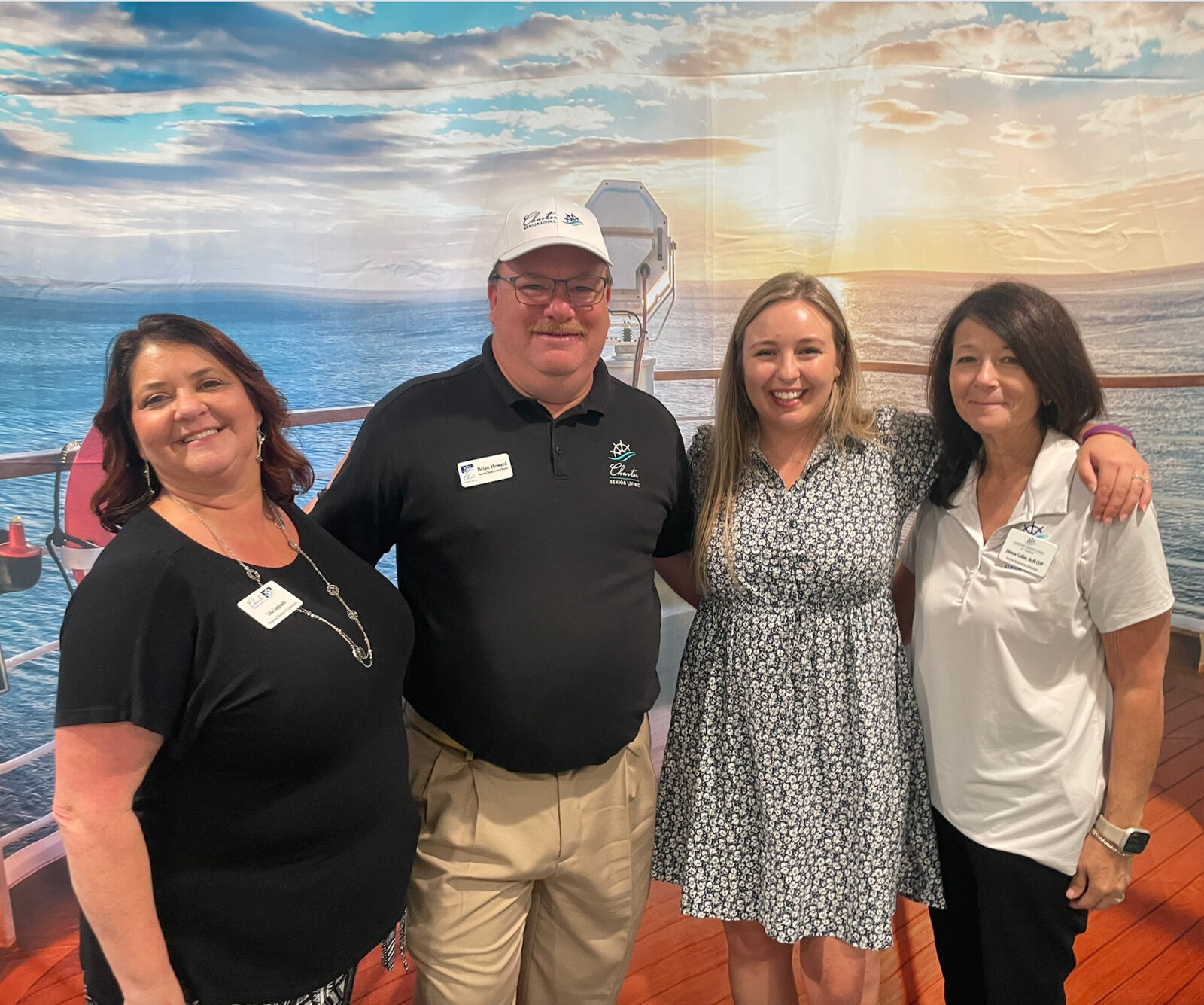 four members smiling for the camera